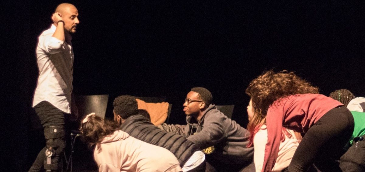 Hypnotized volunteers acting out a scene on stage