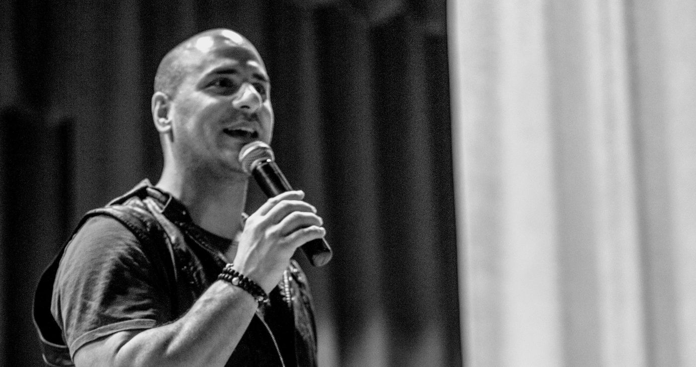 Eric Mina speaking on stage